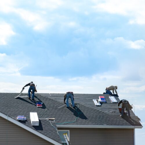 4 construction workers fixing roof against clouds blue sky taylorsville ut